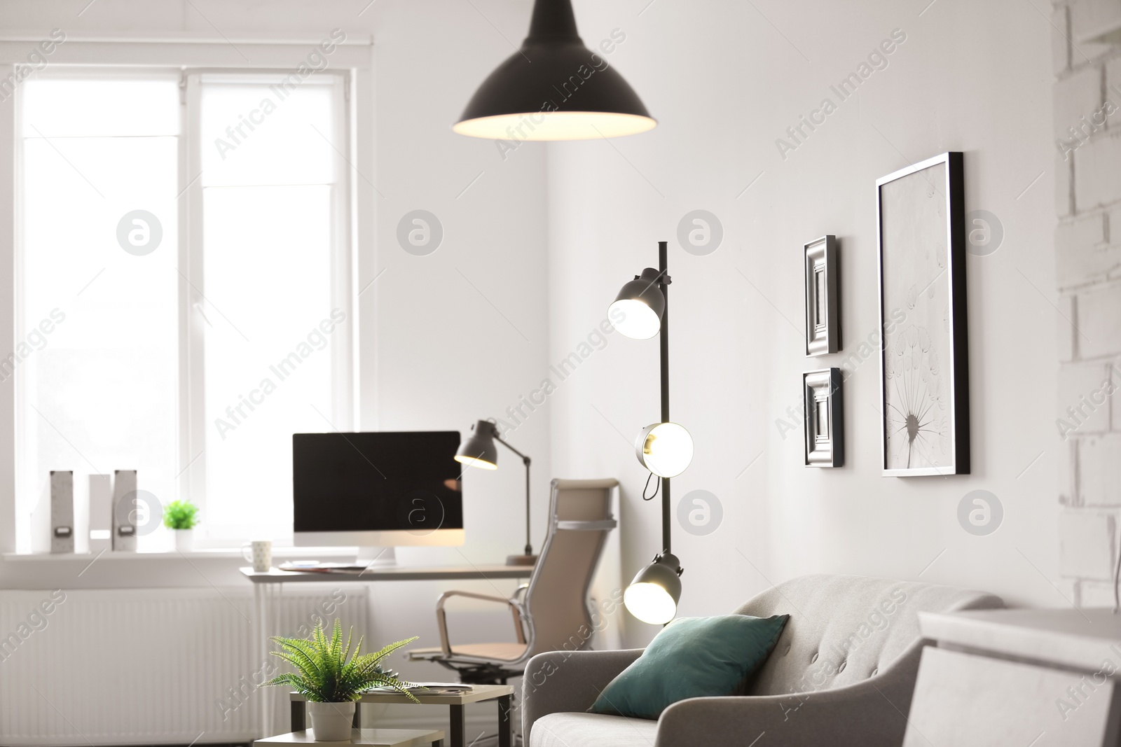 Photo of Room interior with modern lamps and comfortable sofa