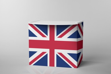 Image of Ballot box decorated with flag of United Kingdom on light background