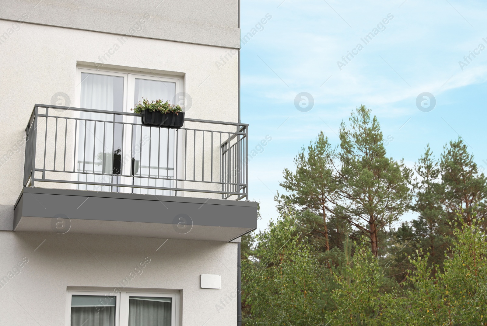 Photo of Beautiful beach house with balcony and trees outdoors