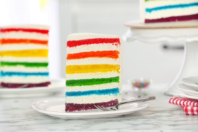 Photo of Delicious rainbow cake for party on table