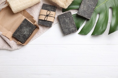 Photo of Flat lay composition with natural tar soap on white wooden table. Space for text