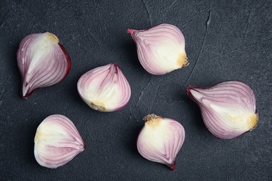 Photo of Ripe cut red onions on dark background