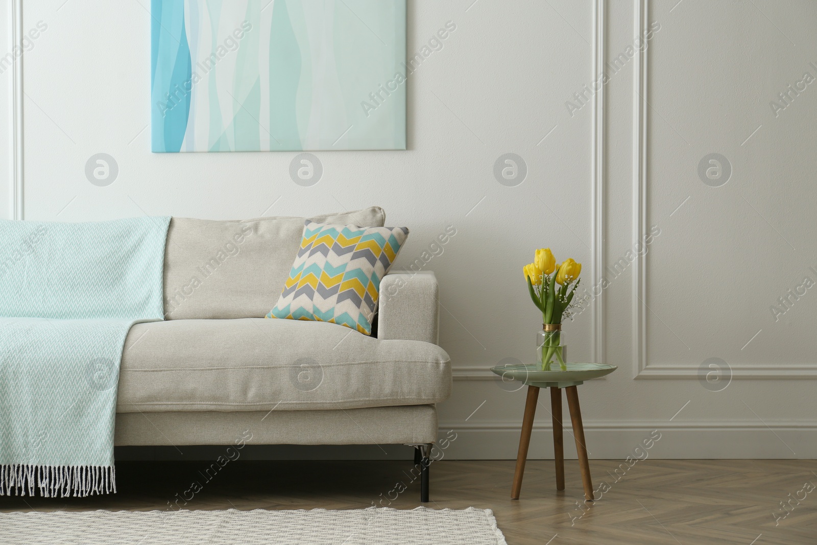 Photo of Stylish beige sofa in living room interior