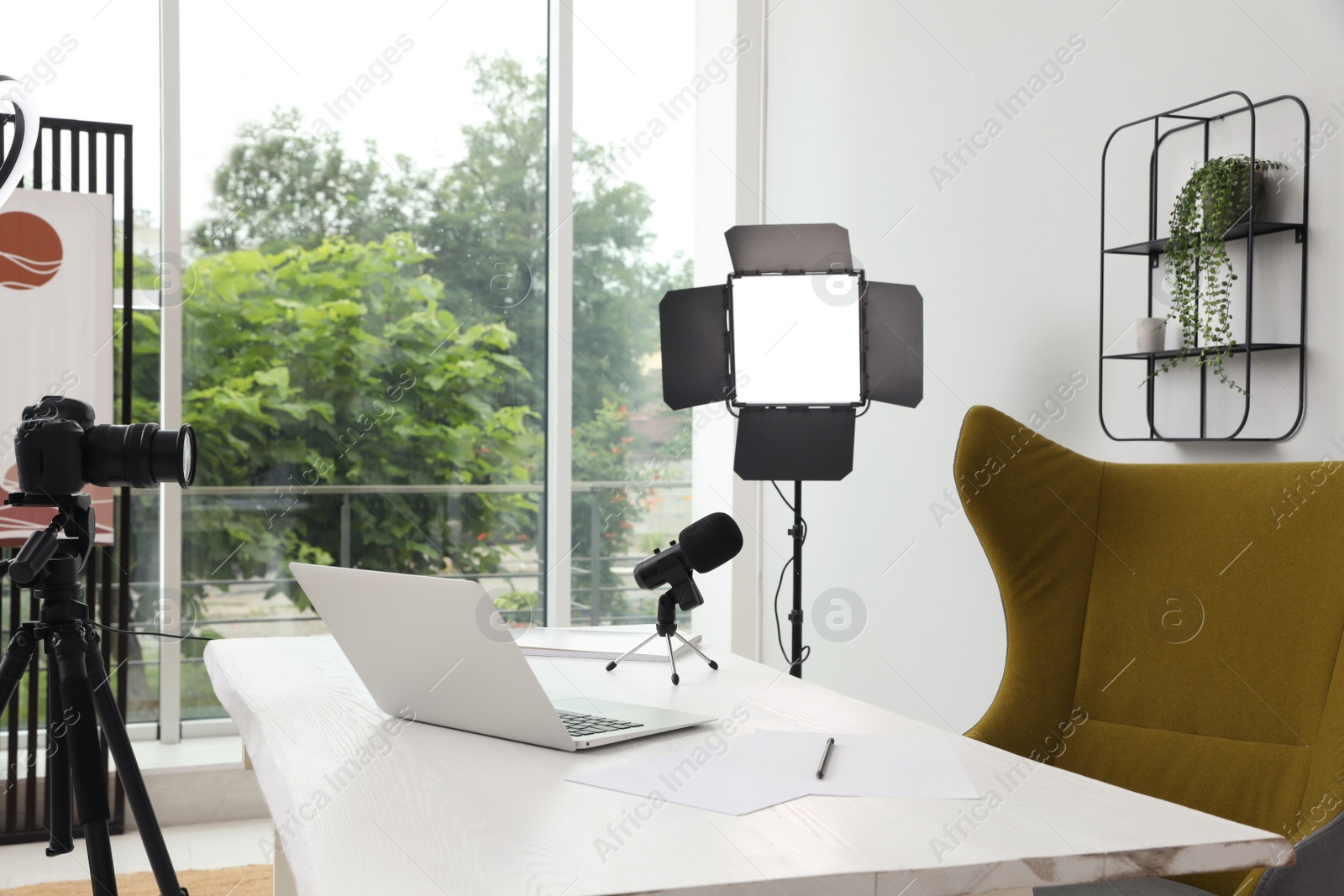 Photo of Modern blogger's workplace with professional equipment and laptop in room