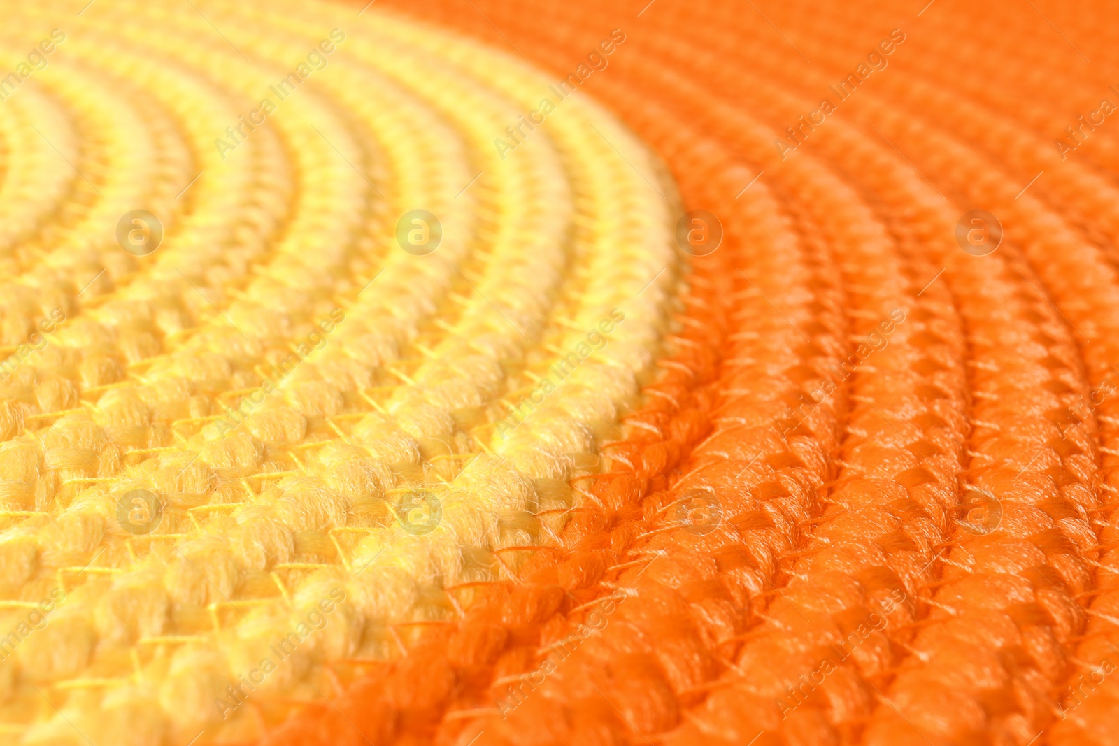 Photo of Orange and yellow wicker mat texture as background, closeup