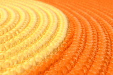 Photo of Orange and yellow wicker mat texture as background, closeup