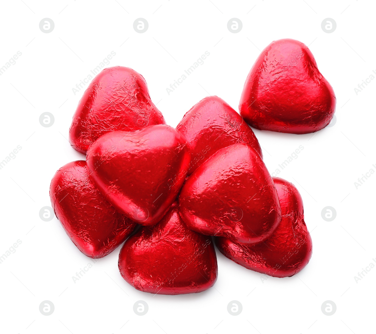 Photo of Heart shaped chocolate candies in red foil on white background, top view