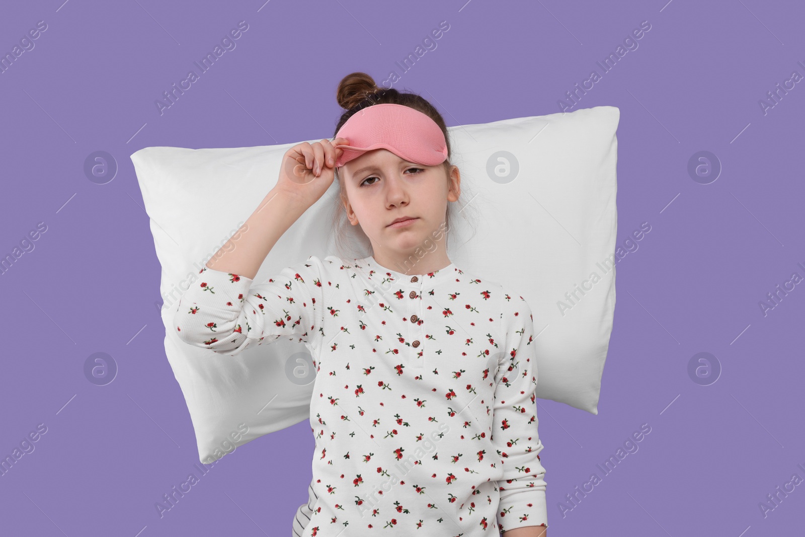 Photo of Girl with sleep mask and pillow on purple background. Insomnia problem