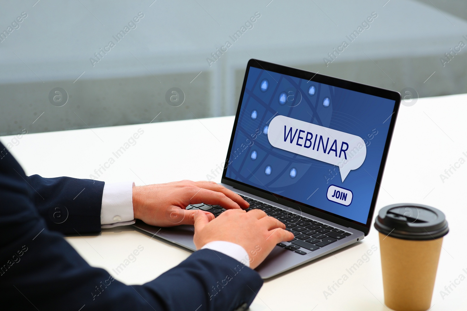 Image of Online webinar, web page on computer screen. Man using laptop at white table, closeup