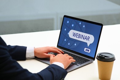 Online webinar, web page on computer screen. Man using laptop at white table, closeup