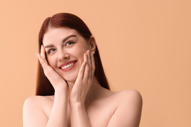 Photo of Portrait of smiling woman on beige background. Space for text