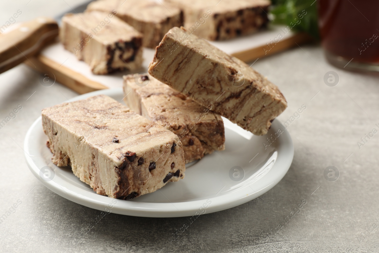 Photo of Tasty chocolate halva on grey table, closeup