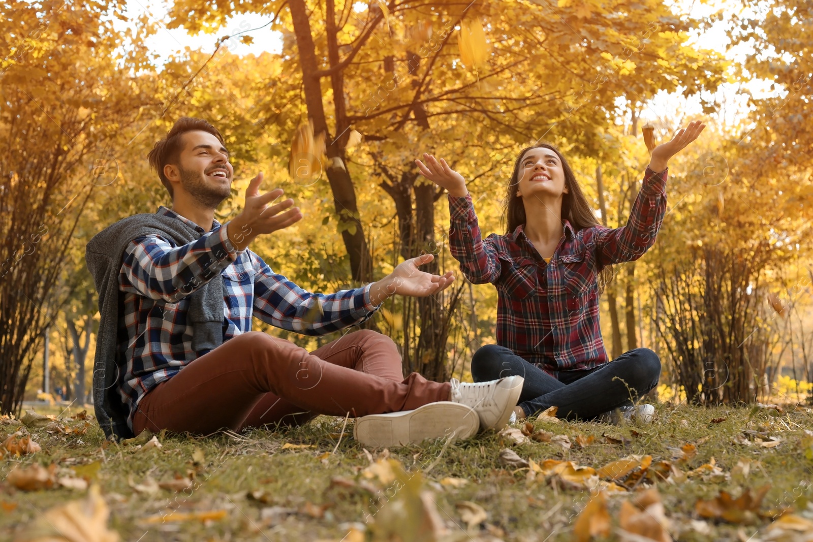 Photo of Young lovely couple spending time together in park. Autumn walk