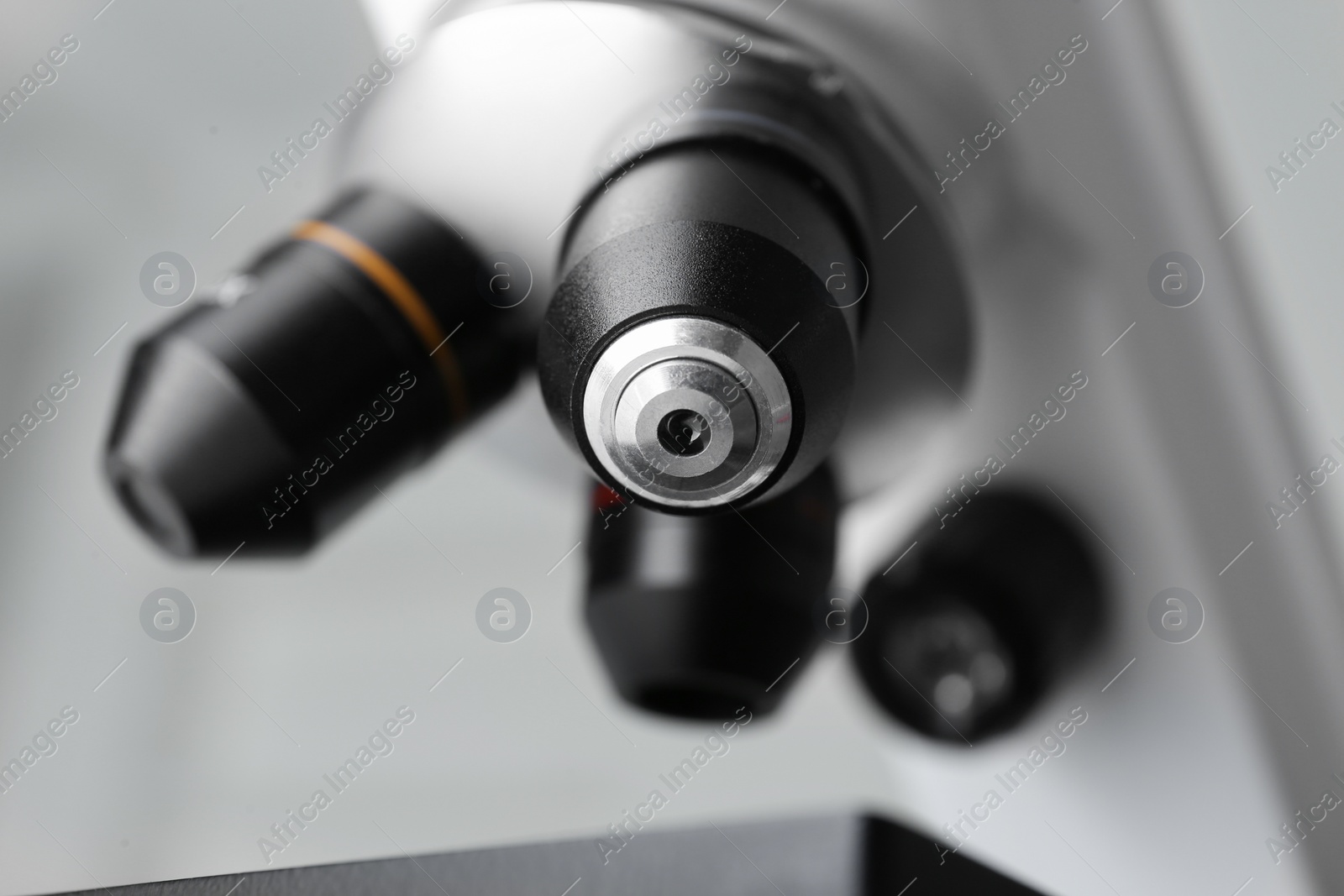 Photo of Closeup view of modern medical microscope on grey background