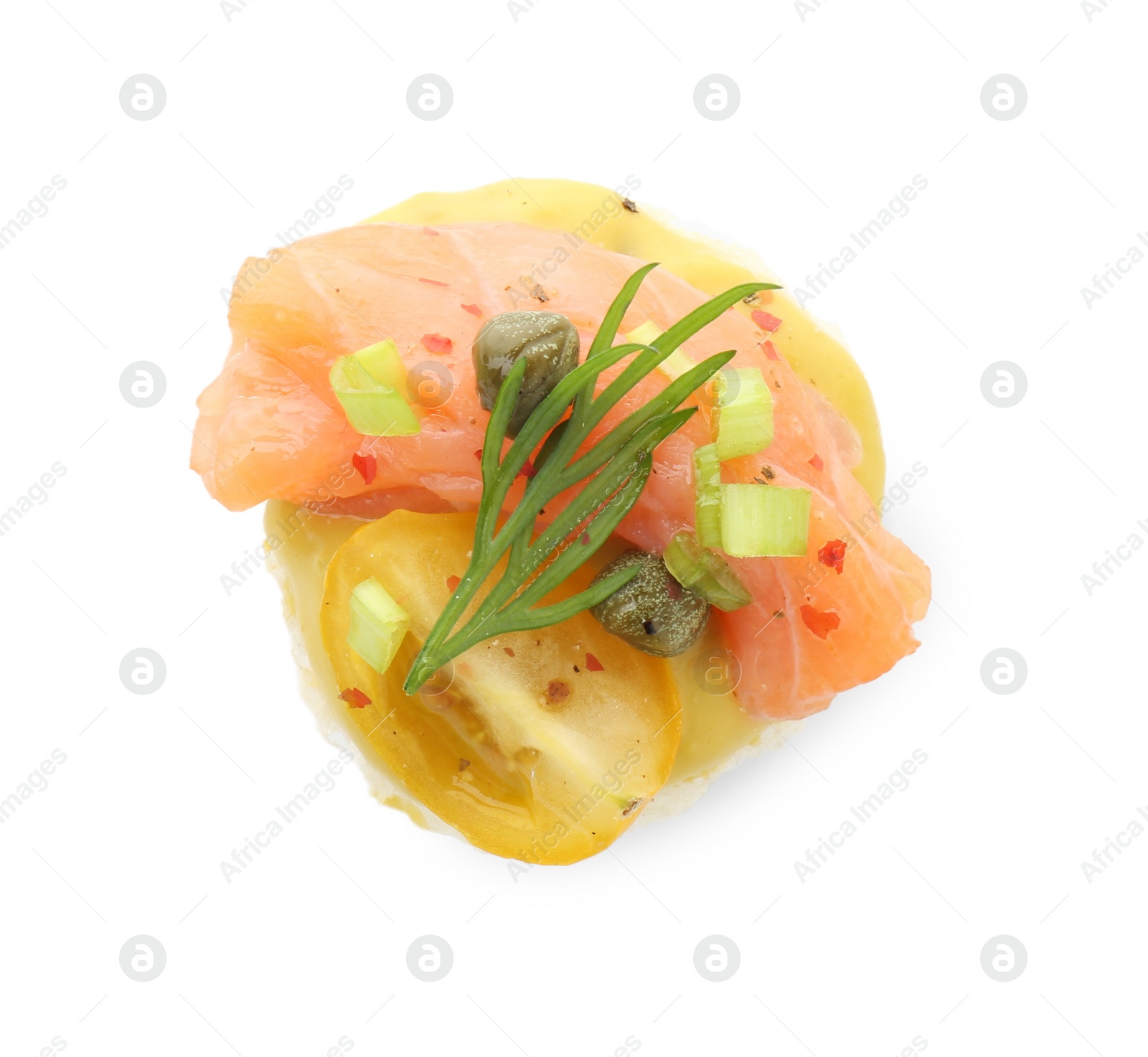 Photo of Tasty canape with salmon, tomatoes, capers and herbs isolated on white, top view