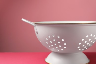 Photo of One clean empty colander on color background, closeup