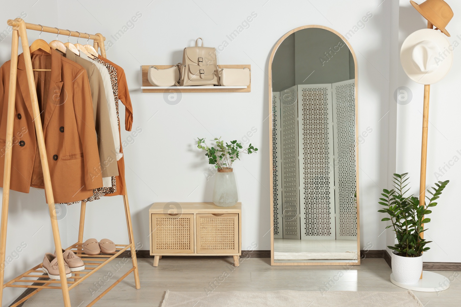 Photo of Modern hallway room interior with large mirror and clothing rack