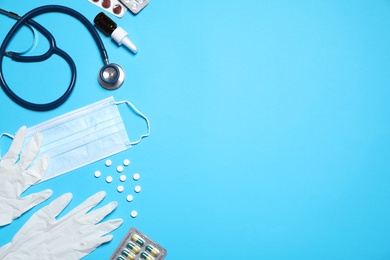 Different medical items on light blue background, flat lay. Space for text
