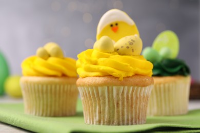 Tasty cupcakes with Easter decor on table, closeup