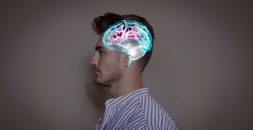 Thinking concept. Young man and illustrated brain on color background