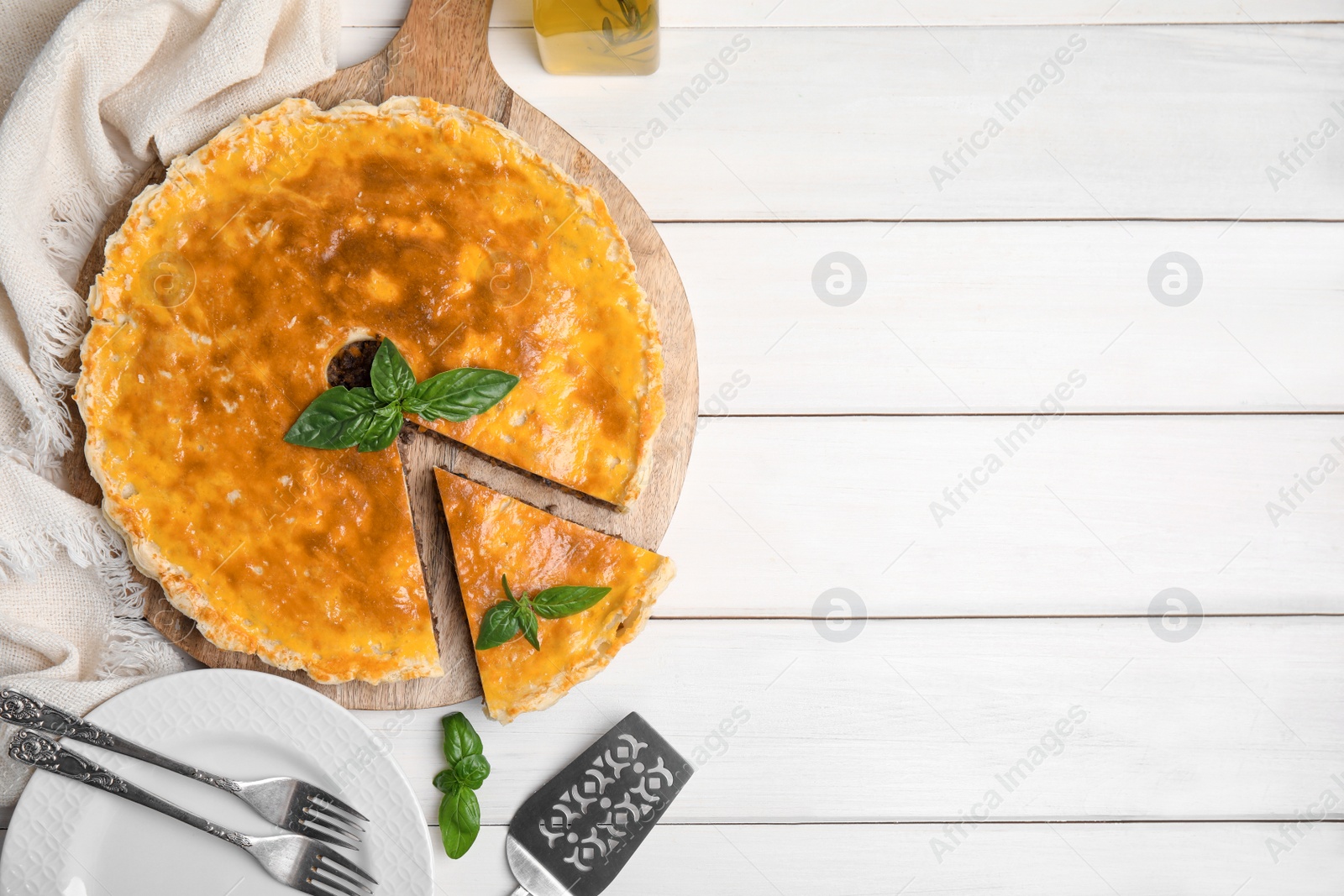 Photo of Delicious pie with minced meat on white wooden table, flat lay. Space for text