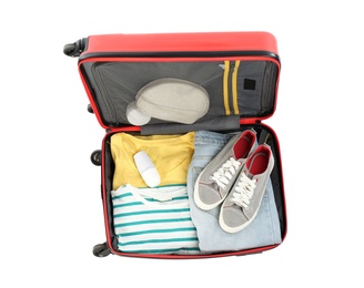 Packed suitcase with deodorant and clothes on white background, top view