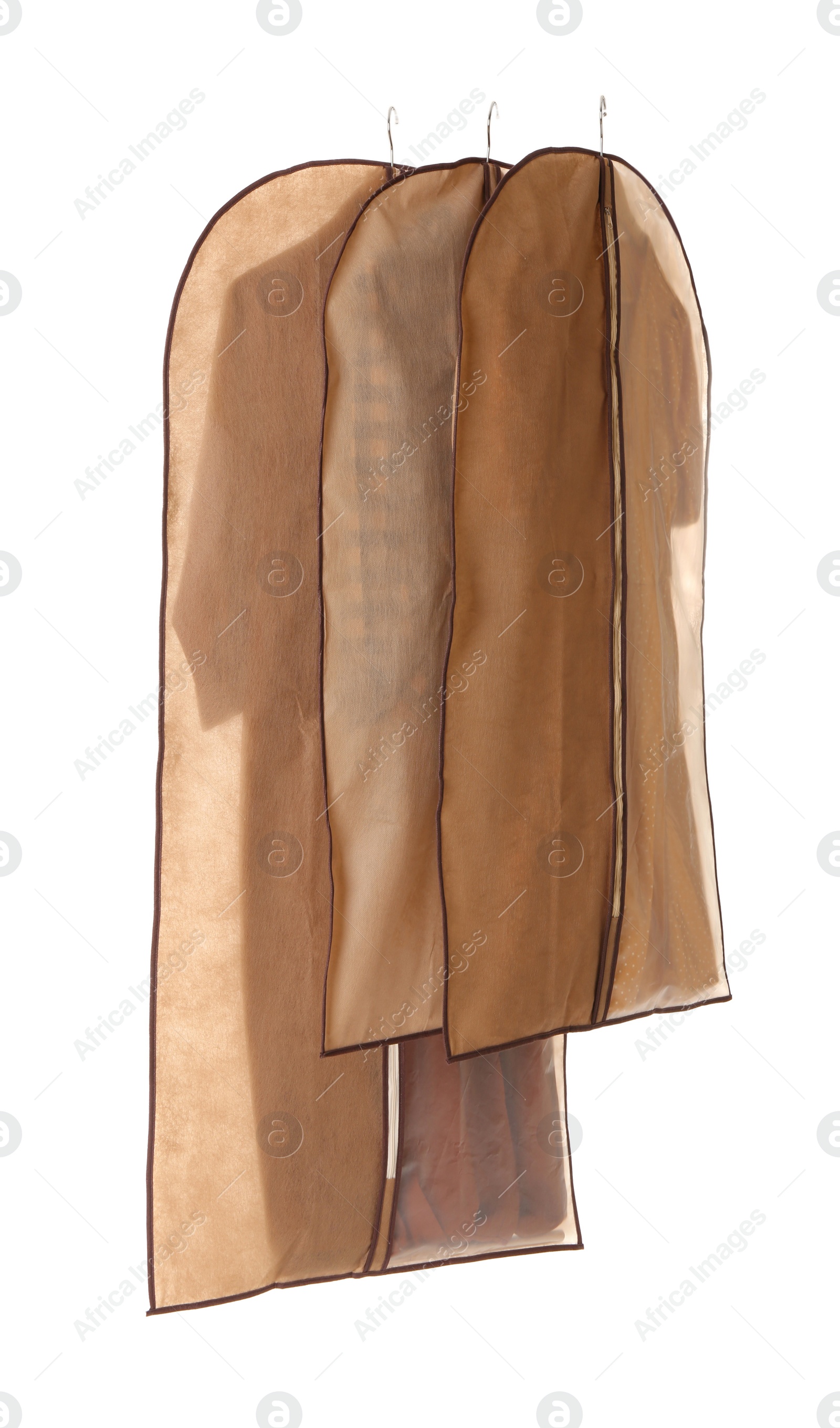 Photo of Garment bags with clothes on white background