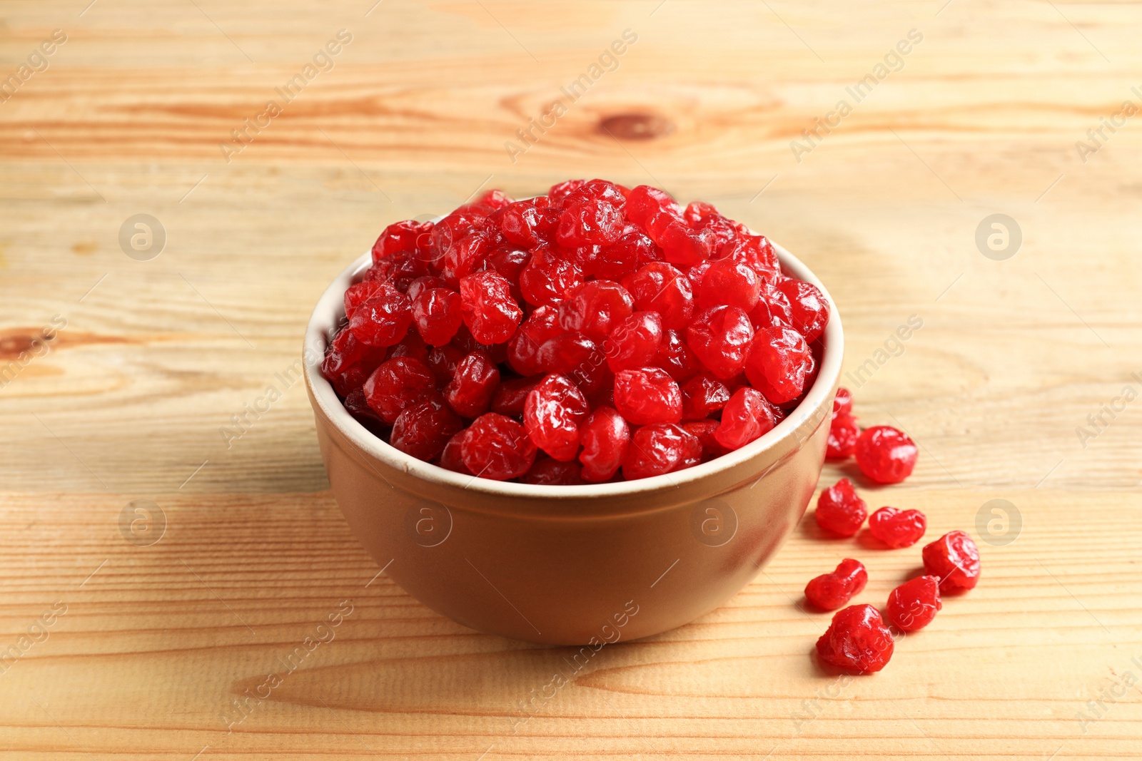 Photo of Bowl of sweet cherries on wooden background. Dried fruit as healthy snack