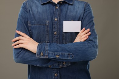 Photo of Woman with blank badge on grey background, closeup