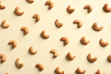 Tasty cashew nuts on light background, flat lay