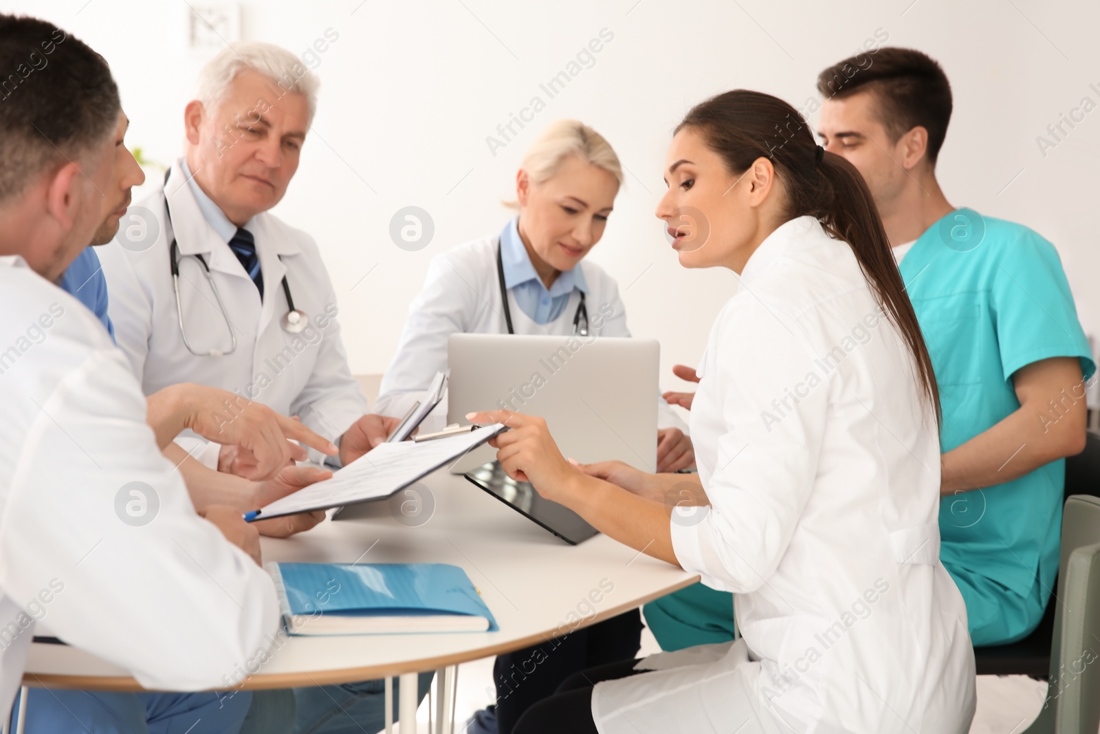 Photo of Group of doctors attending meeting in clinic. Cardiology conference