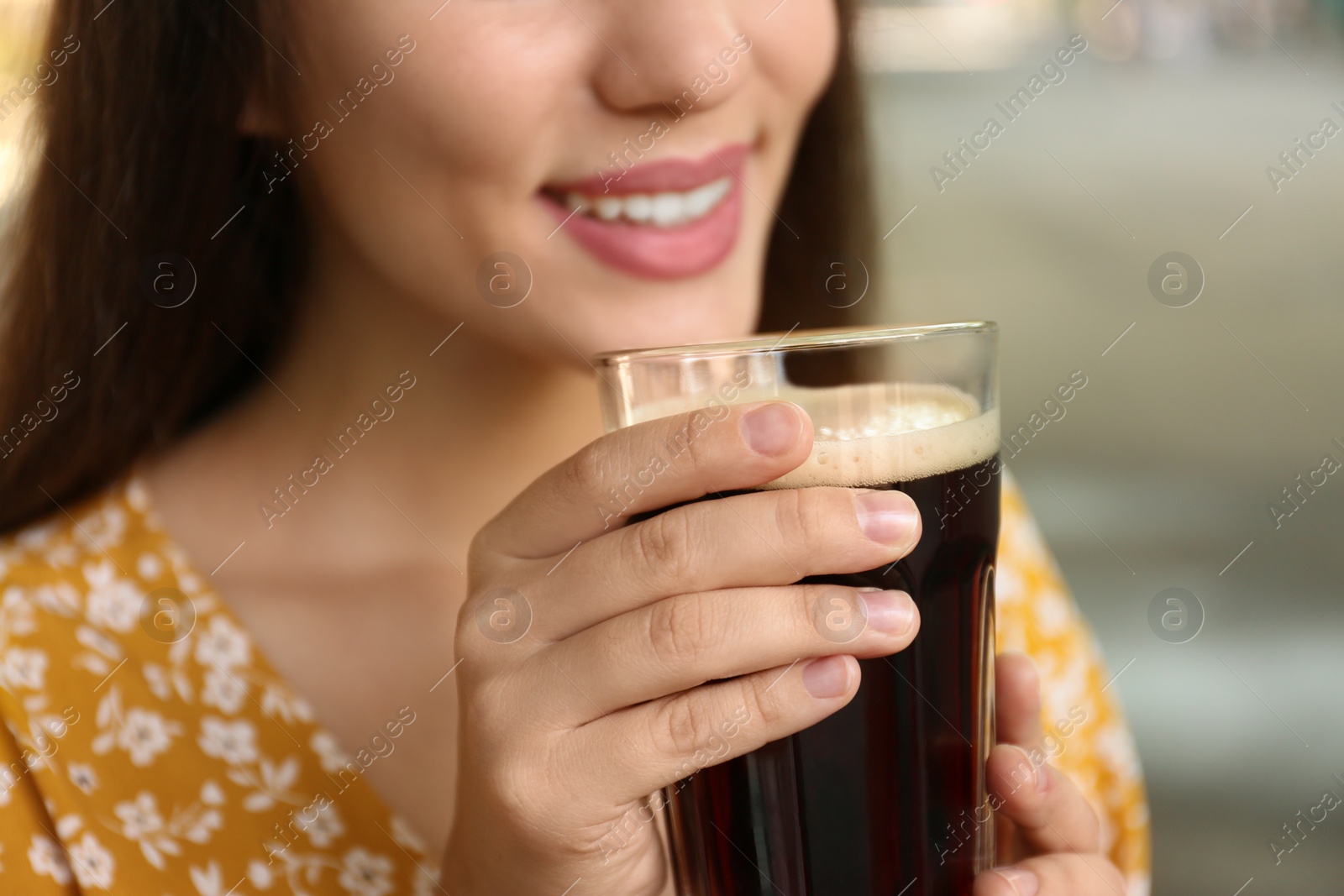 Photo of Young woman with cold kvass outdoors, closeup. Traditional Russian summer drink