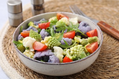 Photo of Delicious salad with cauliflower and tomato served on table, closeup