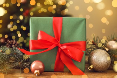 Beautiful gift box and Christmas decor on wooden table, closeup