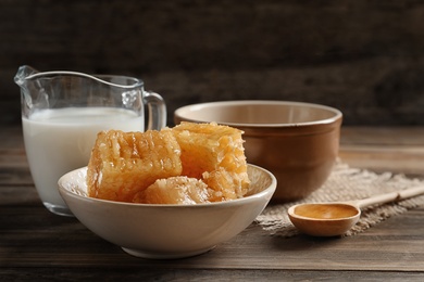 Photo of Composition with milk and honey on wooden table