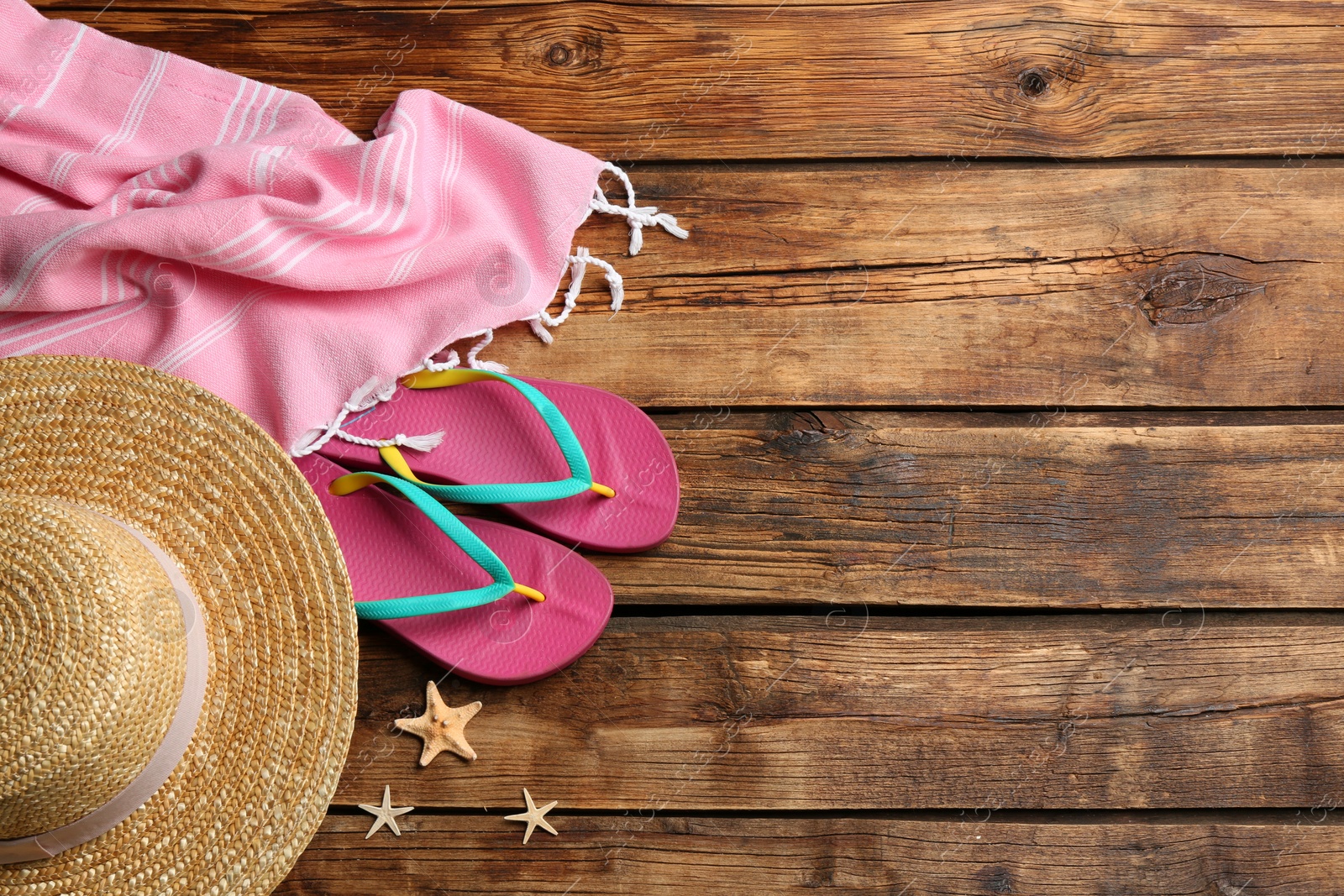 Photo of Beach accessories on wooden table, flat lay. Space for text