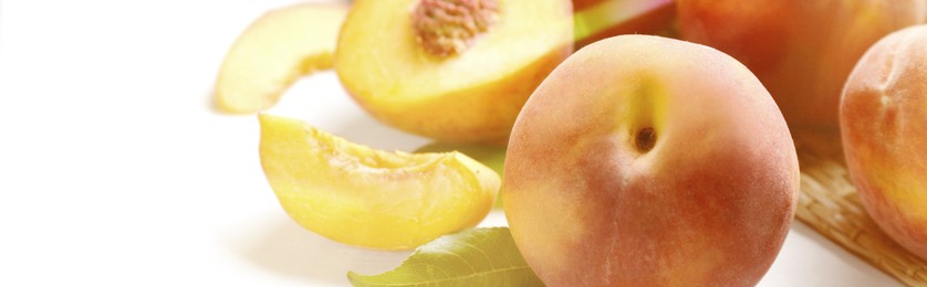 Fresh ripe peaches on white table, closeup. Banner design with space for text