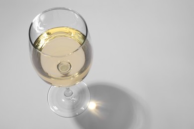 Tasty aromatic wine in glass isolated on white, above view