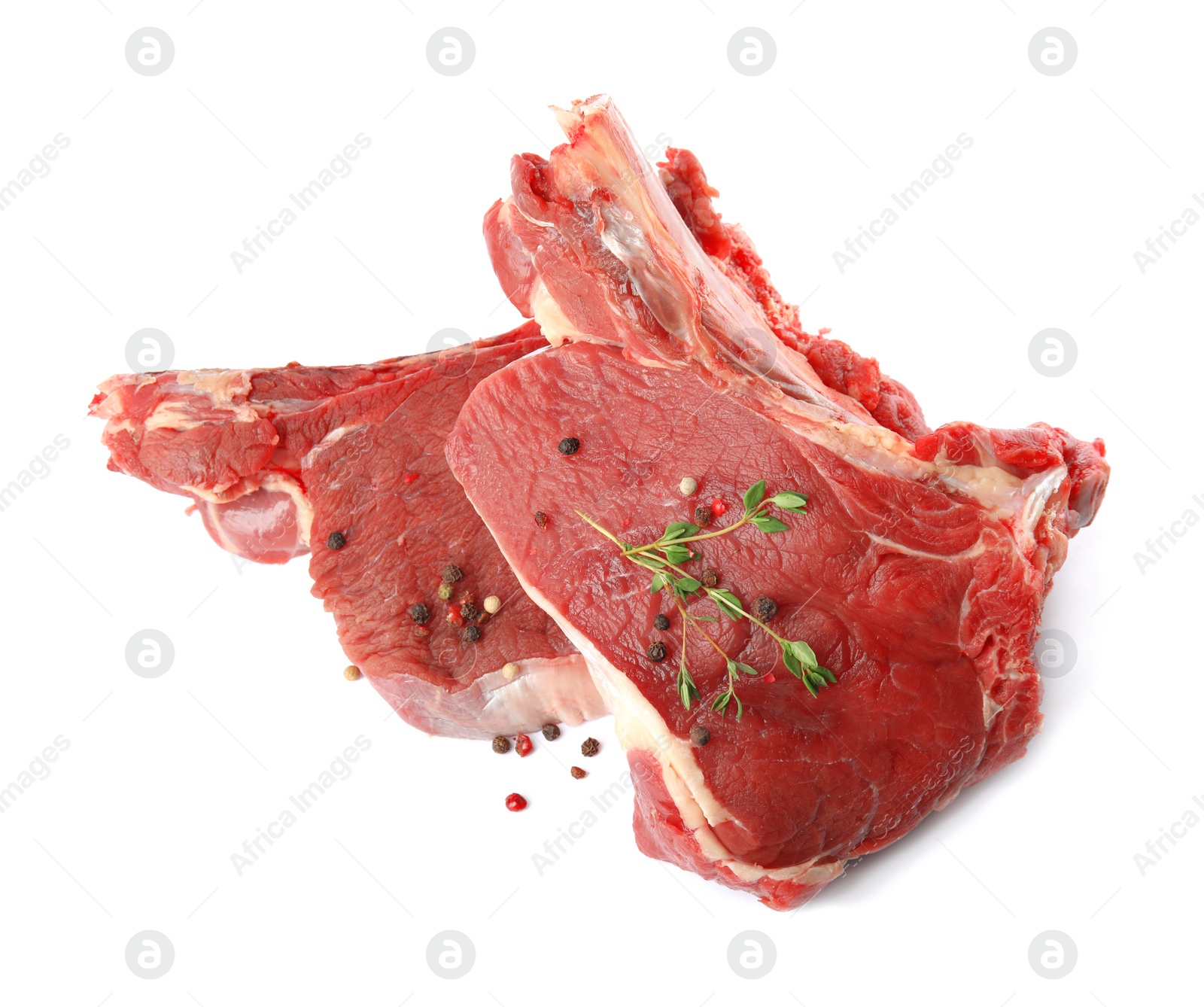 Photo of Fresh raw beef cut with thyme and peppers mix isolated on white, above view