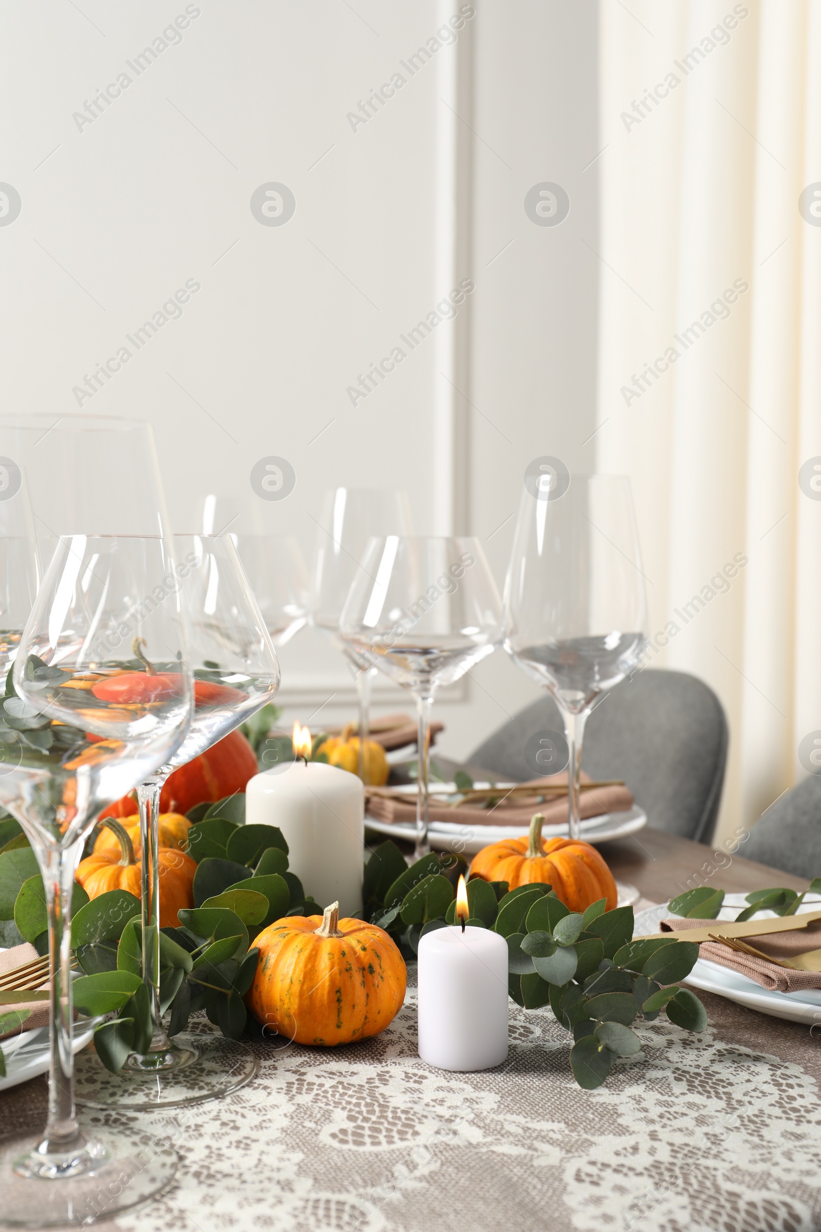 Photo of Beautiful autumn table setting. Plates, cutlery, glasses, pumpkins and floral decor