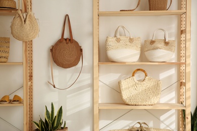 Photo of Stylish woman's bags on shelves in boutique