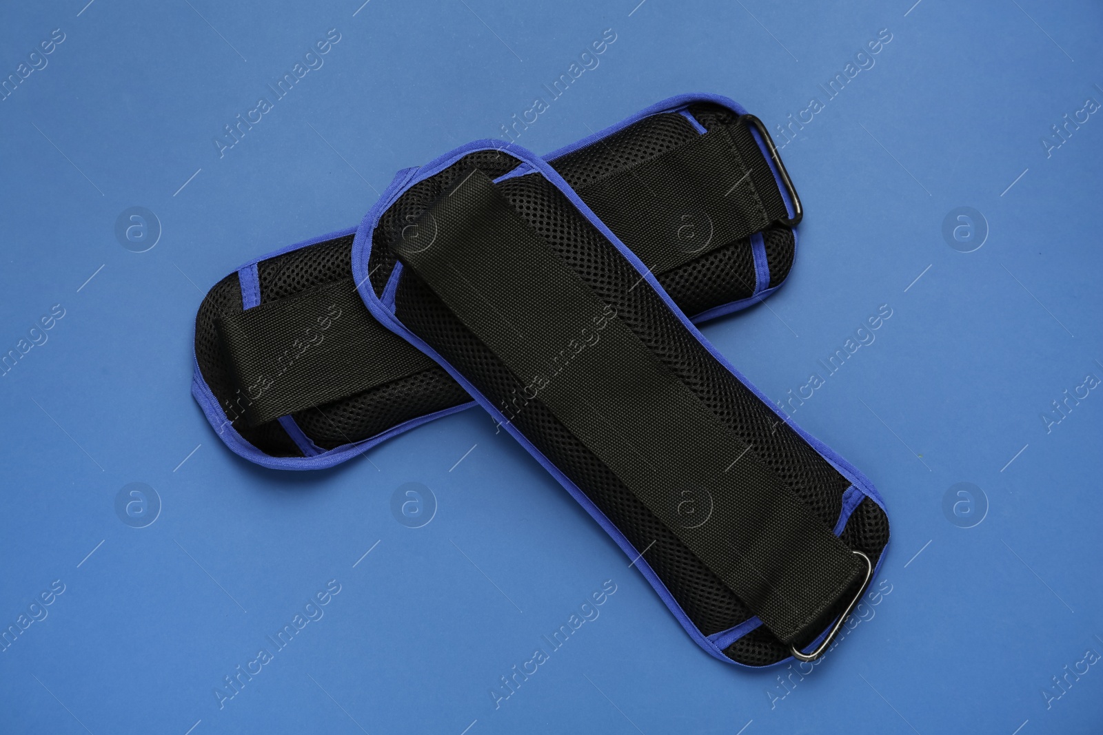 Photo of Stylish weighting agents on blue background, flat lay