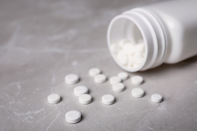 Photo of Bottle with pills on table