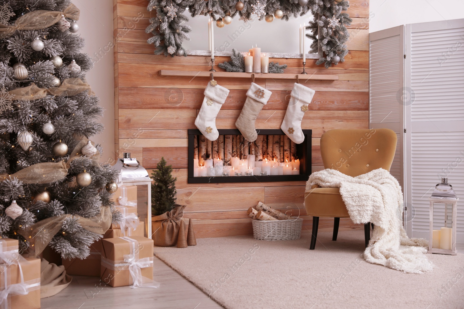 Photo of Fireplace with Christmas stockings in room. Festive interior