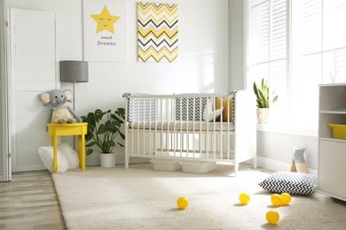 Cute baby room interior with crib and big window