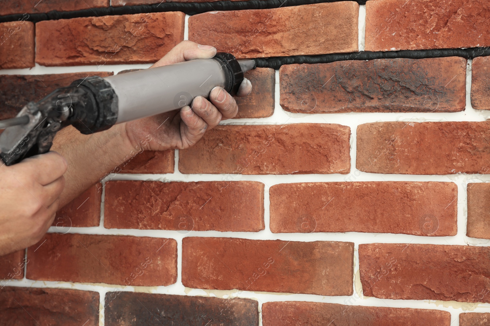 Photo of Professional builder using tiling fugue for grouting, closeup