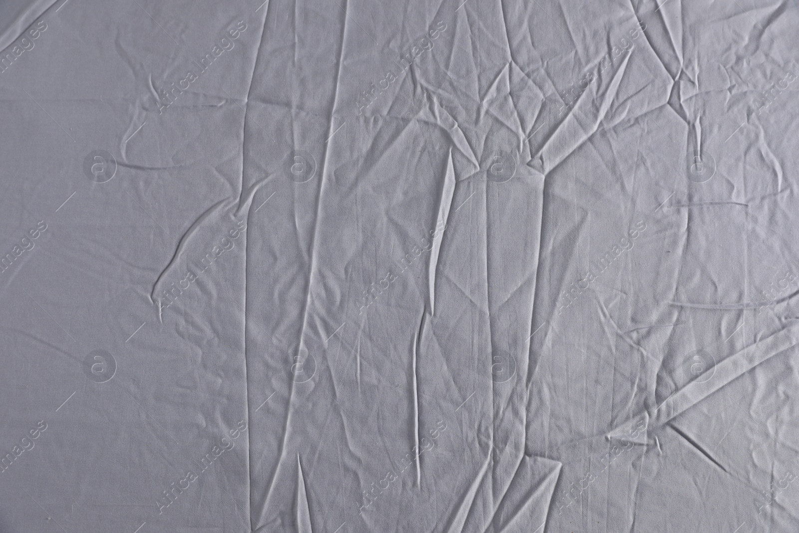 Photo of Crumpled grey fabric as background, top view