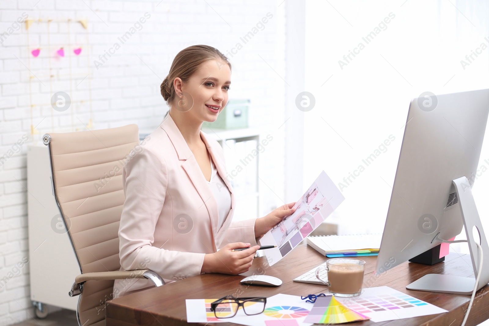 Photo of Female designer working at desk in office