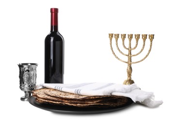 Photo of Tasty matzos, wine and menorah on white background. Passover (Pesach) celebration