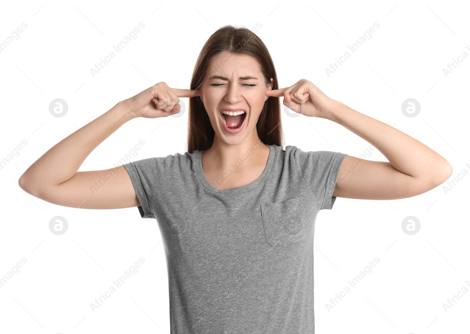 Photo of Emotional young woman covering her ears with fingers on white background